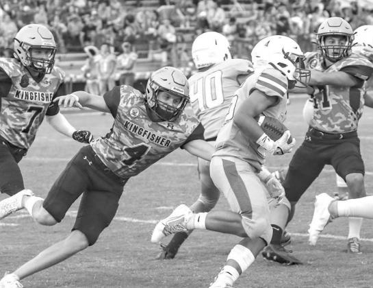 KINGFISHER’S SLADE SNODGRASS (4) closes in for a tackle in the backfield during Kingfisher’s 48-8 win at Chisholm last week. Snodgrass had five tackles and also returned a punt for a touchdown. [Photo by Chris Simon/www.simon-sports-photos.smugmug.com Horns present path to easy win