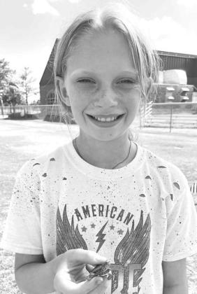TURTLE RACE WINNERS: Above left is Adele Anderson with her winning water turtle, also the smallest entrant in the field. On the right is Ethan Schellenberg, who won the 8-14 year-old division in box turtles. Below is Warren Farrow with his parents, Kierst Turtle Race Winners