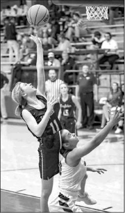 KHS SOPHOMORE Kina Frost goes up for a bucket over a Blackwell defender during her team’s 61-33 win Thursday at the Wheat Capital Tournament. [Photo by Chris Simon/www . KHS SOPHOMORE Kina Frost goes up for a bucket over a Blackwell defender during her team’s 61-33 win Thursday at the Wheat Capital Tournament. [Photo by Chris Simon/www .
