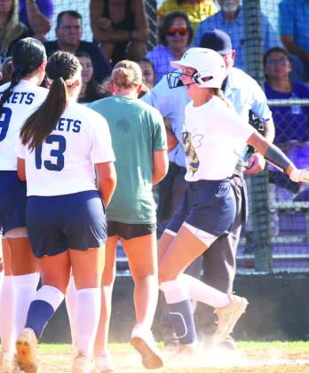 KINGFISHER SENIOR Jancee Matthews is all smiles as she prepares to touch home plate during Kingfi sher’s 6-2 season opening win at Bethany on Tuesday. Matthews is elated after launching a home run to left-center field in the fifth inning. She wasn’t d