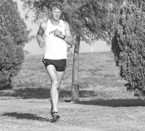 CONNER HINE, pictured running earlier this season at the Kingfisher meet, won the boys race last Friday at the Mooreland Cross Country Invitational. It was Hine’s first career win in his final regular-season meet. [Photo by Chris Simon/www.simon-sports- Article Image Alt Text