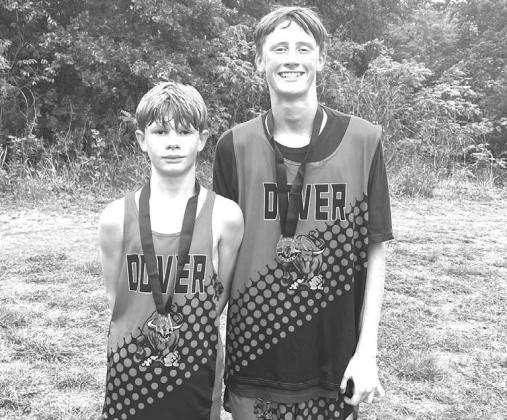 Two Dover Longhorn runners medaled in the junior high boys race Saturday, Aug. 30, at the Watonga High School Invitational. Hunter Spradlin, left, placed 11th out of 115 competitors. He ran the 2,500 meter course in 9:26.7. His teammate Brady Reese placed