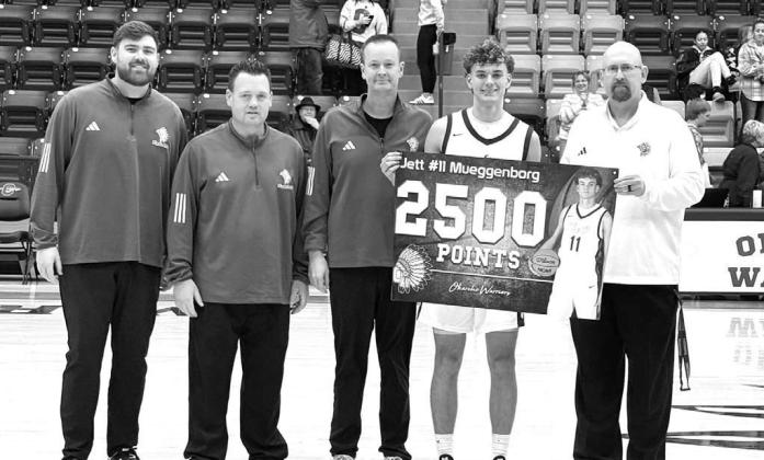 OKARCHE’S Jett Mueggenborg was presented a banner to commemorate his passing the 2,500 career points total on Wednesday. He scored 33 points in Okarche’s 96-48 win over Crescent. Pictured are, from left, Okarche coaches Hunter Frisby, Brandon Treece a OKARCHE’S Jett Mueggenborg was presented a banner to commemorate his passing the 2,500 career points total on Wednesday. He scored 33 points in Okarche’s 96-48 win over Crescent. Pictured are, from left, Okarche coaches Hunter Frisby, Brandon Treece a