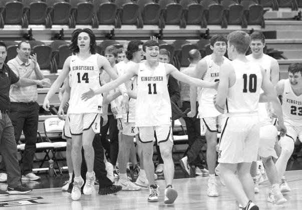 HUG IT OUT — Kingfisher players gather to celebrate their area championship win last Friday against Holland Hall. The win puts KHS back into the state tournament for a fifth straight year. The Jackets play Blanchard Wednesday in the quarterfinal round. Hall decked; ticket punched