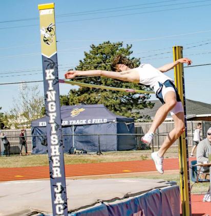 KINGFISHER’S BRAXTON Mecklenburg clears the bar during a high jump attempt at last week’s KHS Track and Field Invitational. He won first place in the event On the right is Mason Mecklenburg running a relay earlier this season. He won four medals, incl A ‘Meck’ of a Day for KHS trio