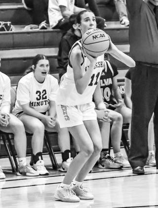 ELA HARTMAN eyes a 3-pointer in the first half against Alva. Her offense and defense played big roles in Kingfisher’s 15-point victory. [Photo by Chris Simon/www.simon-sports-photos. smugmug.com]