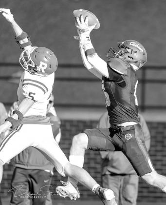 GAME WINNER – Cashion’s Mason Manning soars over Ringling defensive back Chase Taylor to catch this 9-yard touchdown pass from Ben Harman. The score came with just eight seconds remaining and lifted Cashion to a 21-14 victory over the Blue Devils in t MANNING AMONG BOYS