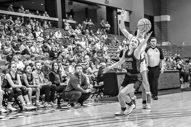 LOMEGA SENIOR Kate Myers (32) reaches for the ball during Lomega’s area consolation final against Leedey on Saturday. Leedey won 40-39 to eliminate the Lady Raiders from the playoffs. [Photo by Chris Simon/www.simon-sports-photos.smugmug. com]