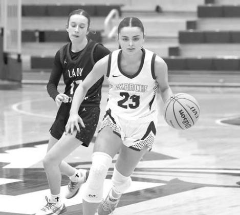 KATE BAUSTERT dribbles it up the floor during Okarche’s area title game loss to Am-Po. The Lady Warriors rebounded to win Saturday and advance to state. [KT&amp;FP Staff Photo]