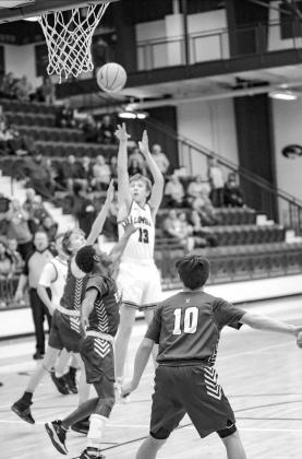 LOMEGA’S Blake Snowden puts up a shot that proved to be the game-winner Saturday in a double-overtime victory against No. 9 Kinta in a Class A area consolation game. Snowden also hit a shot late in the first overtime to push the game into the second ext WILD RIDE