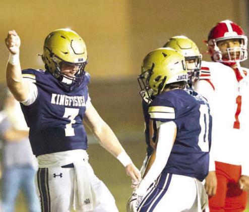 KINGFISHER’S BACKFIELD duo of quarterback Jhett Birdwell (7) and Brett Calamateo (0) celebrate after Birdwell scored a rushing touchdown in the first half of the team’s win over North Rock Creek. [Photo by Chris Simon/www.simon-sports-photos.smugmug.c