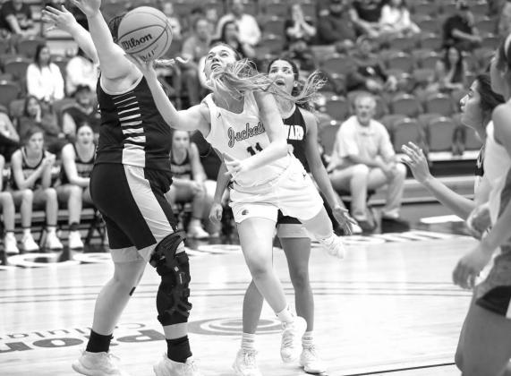 KHS SENIOR Makina Frost makes her signature move while trying to score Saturday night against Woodward. Frost scored 18 points in the 40-30 victory, which put the Lady Jackets into the state tournament for the first time since the 2009 season. [Photo by R Frost, Walker deliver for KHS