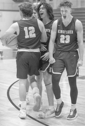 KHS SENIORS Ian Daugherty (12), Bijan Cortes and Matthew Stone(23) celebrate after the final buzzer sounded on their 56-47 win at 5A #1 Carl Albert last Friday. The trio combined for 39 points and 27 rebounds in the victory. [Photo by Kaillin St. Cyrikoww Unexpected Clash of the Titans