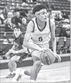 MICHAEL EASLEY drives the baseline Tuesday to score 2 of his 19 points against Tuttle. [Photo by Chris Simon/www.simon- sports-photos.smugmug. com]