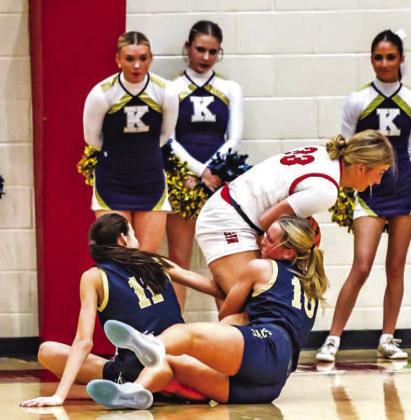 KINGFISHER’S REESE ROOF (10) and Ela Hartman (11) battle Elgin’s Kelby Carter for possession during the Lady Jackets’ 52-51 overtime win. Hartman didn’t finish the game due to a broken nose and Roof hit the game-winning free throw with no time rem