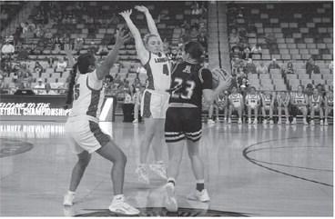 LOMEGA GUARDS Paige Wheeler (4) and Jenny Penaran (5) trap Arnett’s Lauryn Bayless during the third quarter of the Lady Raiders’ quarterfinal win Tuesday at OG&amp;E Coliseum. [KT&amp;FP Staff Photo]