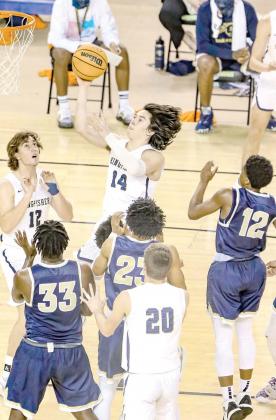 ABOVE ALL OTHERS - Bijan Cortes (14) and the rest of the Kingfisher Yellowjackets stood tall against the competition at the 4A state tournament once again. Cortes scored 23 points in the state title game against Heritage Hall and was named tournament MVP. The Defense Never Rests