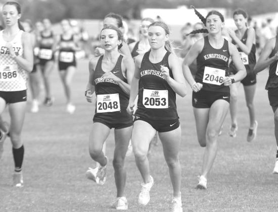 KINGFISHER’S Lily Lunsford (2048), Scout Snodgrass (2053) and Harper Evans (2046) try to make their way to the lead of the pack at the start of Thursday’s cross country race at Heritage Hall. All three runners medaled for KHS as Snodgrass won the individual honor and the team placed second. [KT&FP Staff Photo]