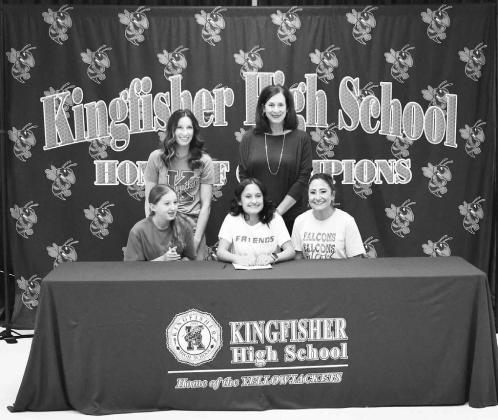 KHS SENIOR Zaylynn Lopez (seated center) signed Tuesday with Friends University. Seated with her are her mother, Amy Rodd (right), and sister Taya Rodd (left). Standing are KHS coaches Shiloh Kannady (left) and Kerri Lafferty (right). [Photo by Andrew Gre Kingfisher’s Lopez signs with Friends