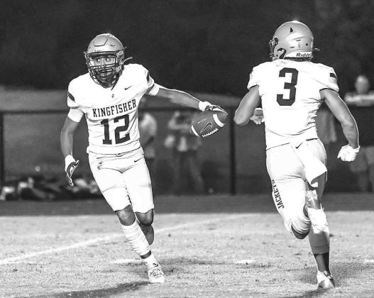 KINGFISHER’S Santiago Ortega (12) fakes a reverse handoff to Kasen Blair (3) on a kickoff return during the Jackets’ game Thursday night at Heritage Hall. [Photo by Chris Simon/www. simon-sports-photos.smugmug.com]