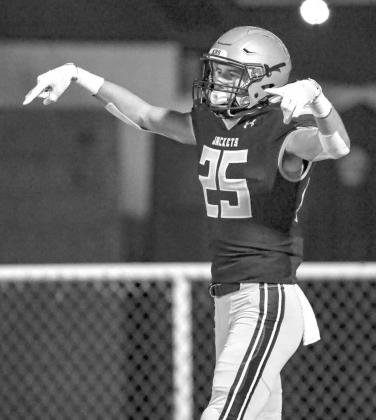 HORNS DOWN - KHS senior Jarret Birdwell offers up a familiar gesture in Oklahoma after he scored one of his two touchdowns against Lone Grove last week. Birdwell had 141 receiving yards and intercepted his third pass in the last two games during Kingfishe Horns down & out