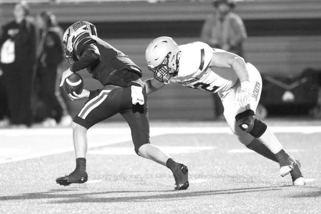KHS SENIOR Cale Reagan tries to pull down Lincoln Christian quarterback Carter Ricke on the first possession of last Friday’s game. Reagan was soon joined by teammate Eduardo De La Torre as the Jackets got a defensive stop to start the game. [Photo by C