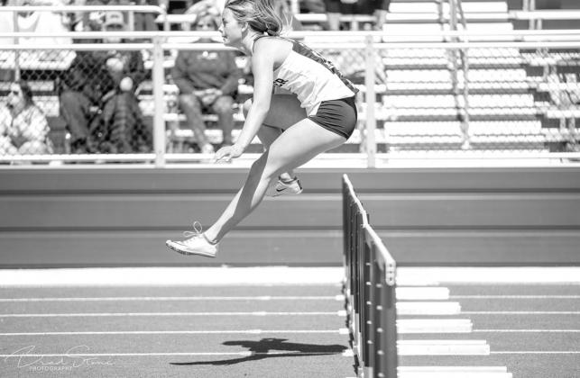 HISTORIC RUNS – Kingfisher’s Ally Stephenson clears a hurdle during a race at Cashion earlier this season. Last week the senior set the KHS records in both the 100 hurdles and 300 hurdles at the Chisholm meet. She now owns five school records in track Hurdles cleared in record books