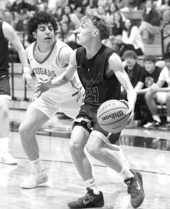 CROSTON MARTIN dribbles down the baseline during the Jackets’ regional final against North Rock Creek. [Photo by Russell Stitt/www.stitt.smugmug.com]