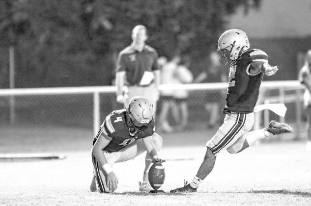 KINGFISHER’S Slade Snodgrass (4) holds the ball for an attempted field goal by Alan Muñoz during a game earlier this season. Muñoz kicked what proved to be a game-winning 25-yard field goal in last Friday’s 30-28 victory at Douglass. [Photo by Chris Muñoz kick saves the day