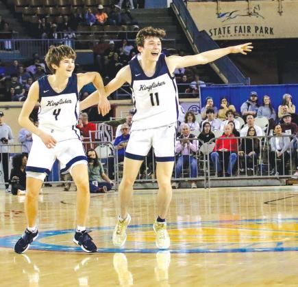 KHS JUNIORS Xavier Ridenour (4) and Maddox Mecklenburg (11) begin to celebrate on the State Fair Arena court after they helped defeat Victory Christian 51-43 to win the Class 4A boys basketball state championship. [Photo by Chris Simon/www.simon-sports-ph THE NEW STANDARD