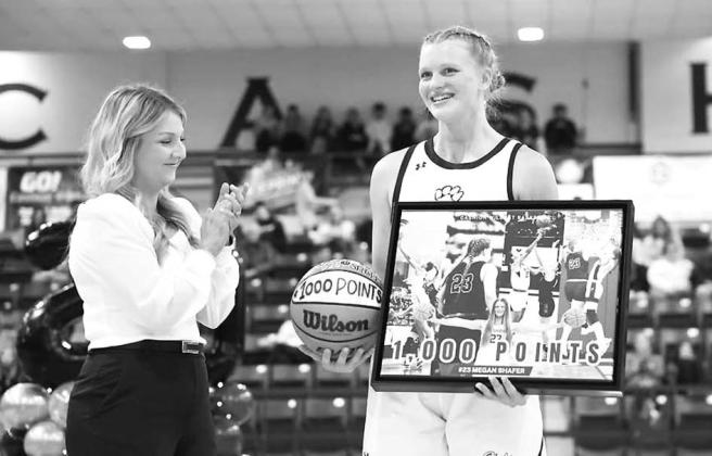 CASHION ASSISTANT coach Ashley Sears congratulates Megan Shafer as she’s recognized for surpassing 1,000 career points. Shafer is also nearing 1,000 career rebounds. [Photo provided]