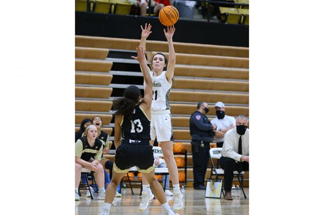 RALLY TIME - Kingfisher girls basketball player, from left, Mya Dewberry Hope Stafford, Addy Matthews and Avery Davis celebrate a Kingfisher bucket early in the fourth quarter of the team’s win over Woodward last Saturday. Article Image Alt Text