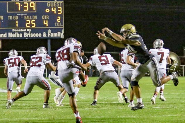 BLOCK PARTY - KHS sophomore Harrison Evans (right) gets his paws on a Weatherford punt during the fourth quarter. Evans blocked the punt, scooped it up and scored a touchdown to get the Jackets back in the game after they had surrendered 27 unanswered poi Article Image Alt Text
