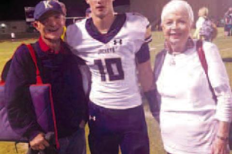 LARRY AND DENA HART are pictured with their grandson Reese after a 2019 KHS football game. Larry Hart is pictured above retrieving his hole-in-one ball on the seventh hole at Kingfisher Golf Course. [Photos provided]