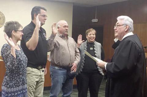 I SWEAR – Judge Robert Davis, far right, delivers the oath of office to, from left, Court Clerk Lisa Markus, Sheriff Dennis Banther, Commissioner Ray Shimanek and County Clerk Jeannie Boevers in January 2017. All four county officers are retiring at the