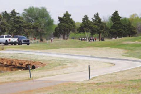 KINGFISHER GOLF COURSE now has a new cart barn (top photo) and improvements near the 18 green, including new rock in the pond, a larger tin horn between two ponds (at the curve on the left) as well as a cart path that was built up several feet and now has