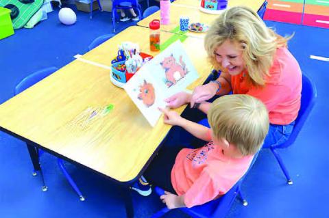 SWARM MENTOR - Tanya Cameron works with a student as a SWARM mentor. Cameron, a former Kingfisher Educational Foundation board member, helped form the mentoring program which now enters its third year. [Photo provided]
