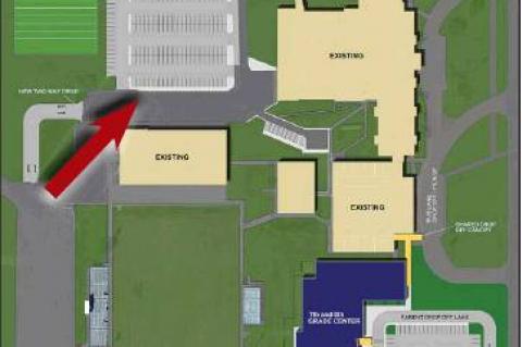 WORK TO BEGIN soon on a new parking lot on the Kingfi sher High School campus (indicated by red arrow, above) to replace existing parking that will be lost in the construction of the 7th &amp; 8th Grade Center.