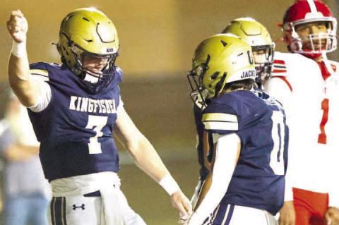 KINGFISHER’S BACKFIELD duo of quarterback Jhett Birdwell (7) and Brett Calamateo (0) celebrate after Birdwell scored a rushing touchdown in the first half of the team’s win over North Rock Creek. [Photo by Chris Simon/www.simon-sports-photos.smugmug.c