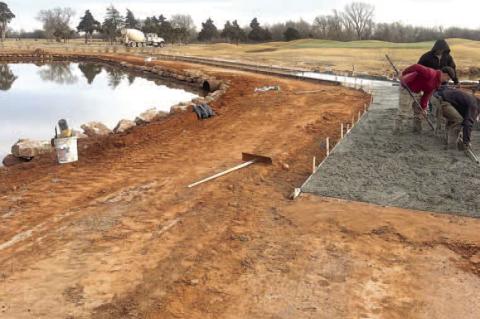 PUTTING IN THE WORK – Pictured above is the area between the 18th green and the pond to its west after dirt was added to raise its level and as new concrete for the cart path is being poured. Below, sod is being added to the area leading up to and surro