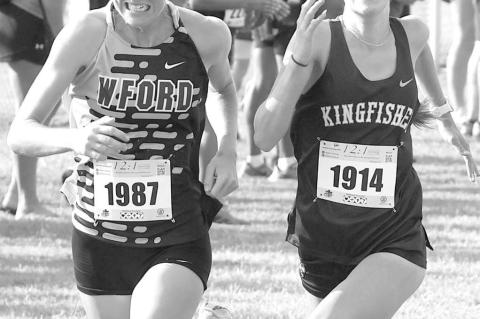 KHS JUNIOR Addison Price and Weatherford’s Cora Hamons battle for position down the stretch at last Saturday’s Sand Plum Invitational. Hamons edged Price at the finish line as the pair were fifth and sixth, respectively. However, Price’s KHS team do
