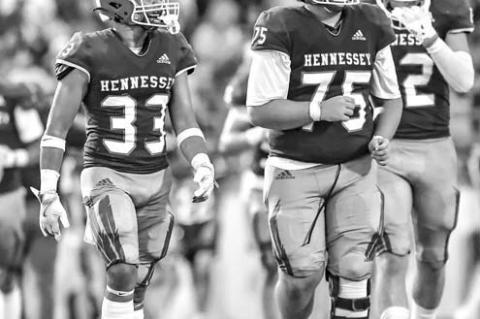 HENNESSEY’S Jakob Johns (33) and Titan Root (75) combined for 13 tackles Thursday night. [Photo by Chris Simon/ www.simon-sports-photos.smugmug.com]