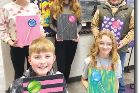 OKARCHE ART – Top left: Juniors Cami White and Stella Krittenbrink make a strawberry shortcake table out of insulation foam and resin. Top right: Junior Kennedy Arnold makes the top cover of a book table. Bottom left: Sophomore Henry Austin recreated th