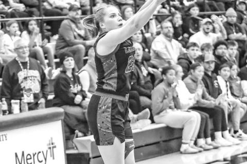 SHARP-SHOOTING Hadley Ott, pictured attempting a 3-pointer at the Bertha Teague Mid-America Classic, was one of the reasons Lomega won its 11th straight Cherokee Strip Conference Tournament championship last week. [Photo by Chris Simon/www.simon- sports-p