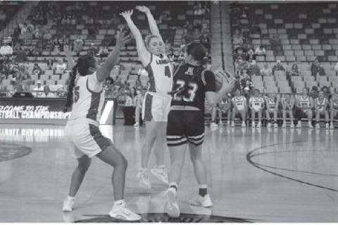LOMEGA GUARDS Paige Wheeler (4) and Jenny Penaran (5) trap Arnett’s Lauryn Bayless during the third quarter of the Lady Raiders’ quarterfinal win Tuesday at OG&amp;E Coliseum. [KT&amp;FP Staff Photo]