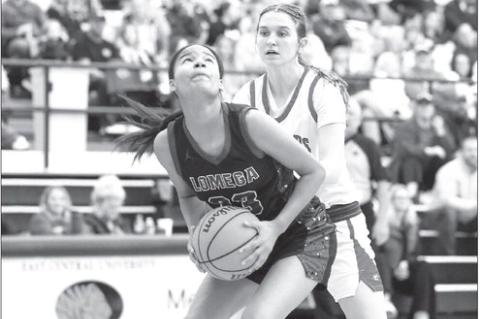 BREE YOST attempts to score in the paint (right) and Hadley Ott shoots a 3-pointer (below) during Lomega’s loss to Washington on Tuesday. [Photos by Russell Stitt/ www.stitt.smugmug.com]