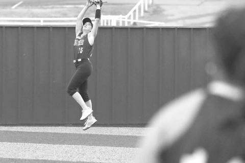 KHS SOPHOMORE Callie Blair makes a leaping catch in right field to rob an extra-base hit during the Lady Jackets’ home win over McGuinness on Monday. [KT&amp;FP Staff Photo]