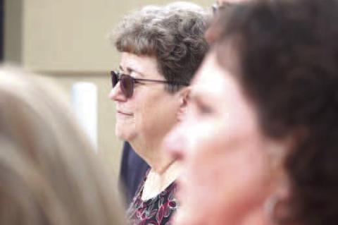 IT’S OFFICIAL – Debbie Biehler cuts the ribbon during a ceremony to christen the Debbie Biehler Annex at Chisholm Trail Technology Center. The annex houses CTTC’s new electrical trades and expanded welding programs. She’s pictured on the right lis