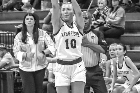 REESE ROOF launches a 3-pointer Thursday as her coach Taylor Young and teammates look on. Roof made four treys and scored 20 points in the Lady Jackets’ regional victory. [Photo by Chris Simon/www. simon-sports-photos.smugmug.com]