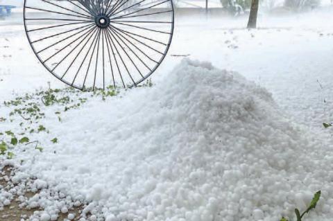 KINGFISHER STREETS and yards look snow-covered Monday evening after a hail storm battered much of the city. This picture was taken on West Meadow Lane on the southwest side of Kingfisher. [Photo provided by Gabriel Perez Jr.]